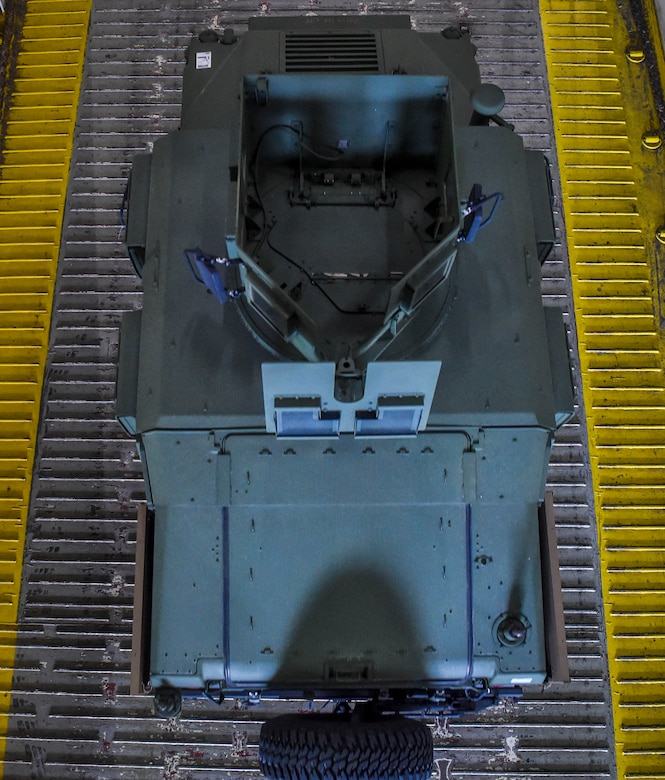 A Humvee is driven onto a ship during an on-load at Joint Base Charleston-Weapons Station, S.C., Sept. 27, 2017.