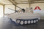 A line of M113A3/BMP-2 Opposing Forces Surrogate Vehicles stand ready for shipping from Anniston Army Depot through DLA Distribution Anniston, Ala. The depot recently completed overhaul of 14 of these training vehicles, which are designed to look like Russian combat vehicles.