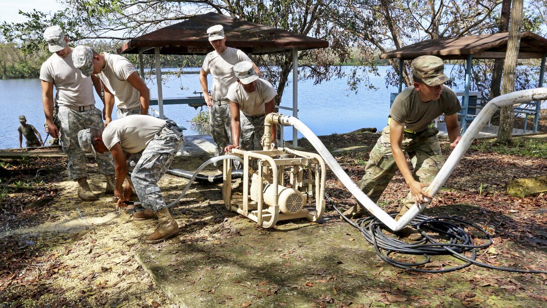 Soldiers use equipment to purify water from a lake.