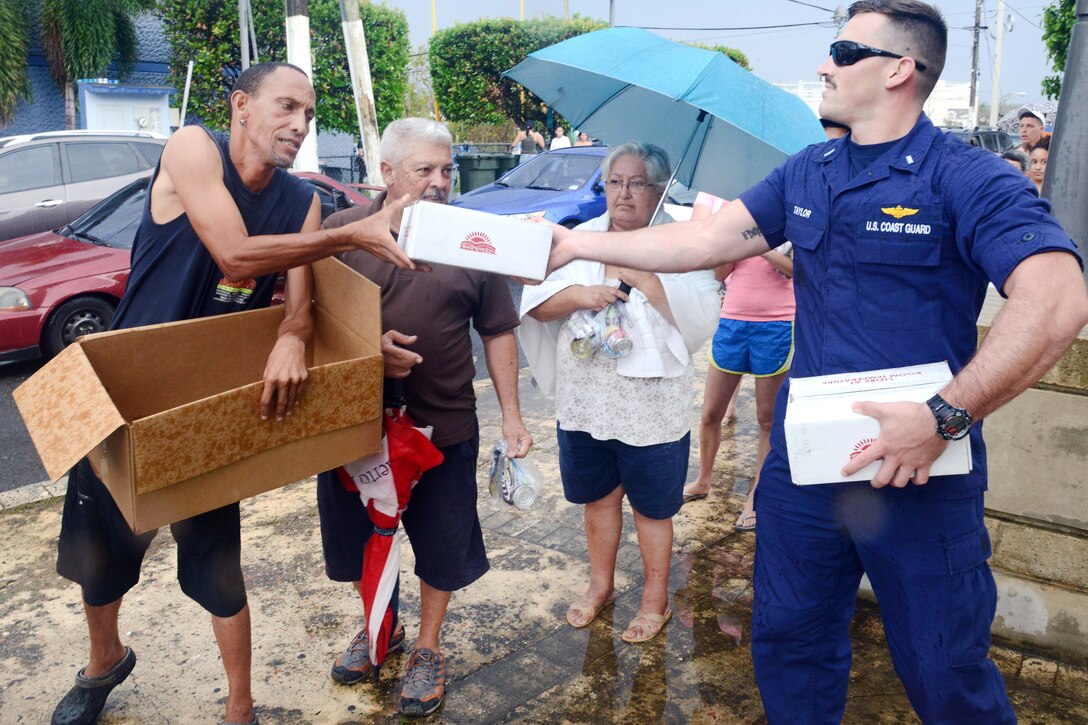 Coast Guard Lt. jg. Lucas Taylor delivers food to residents of Moca.