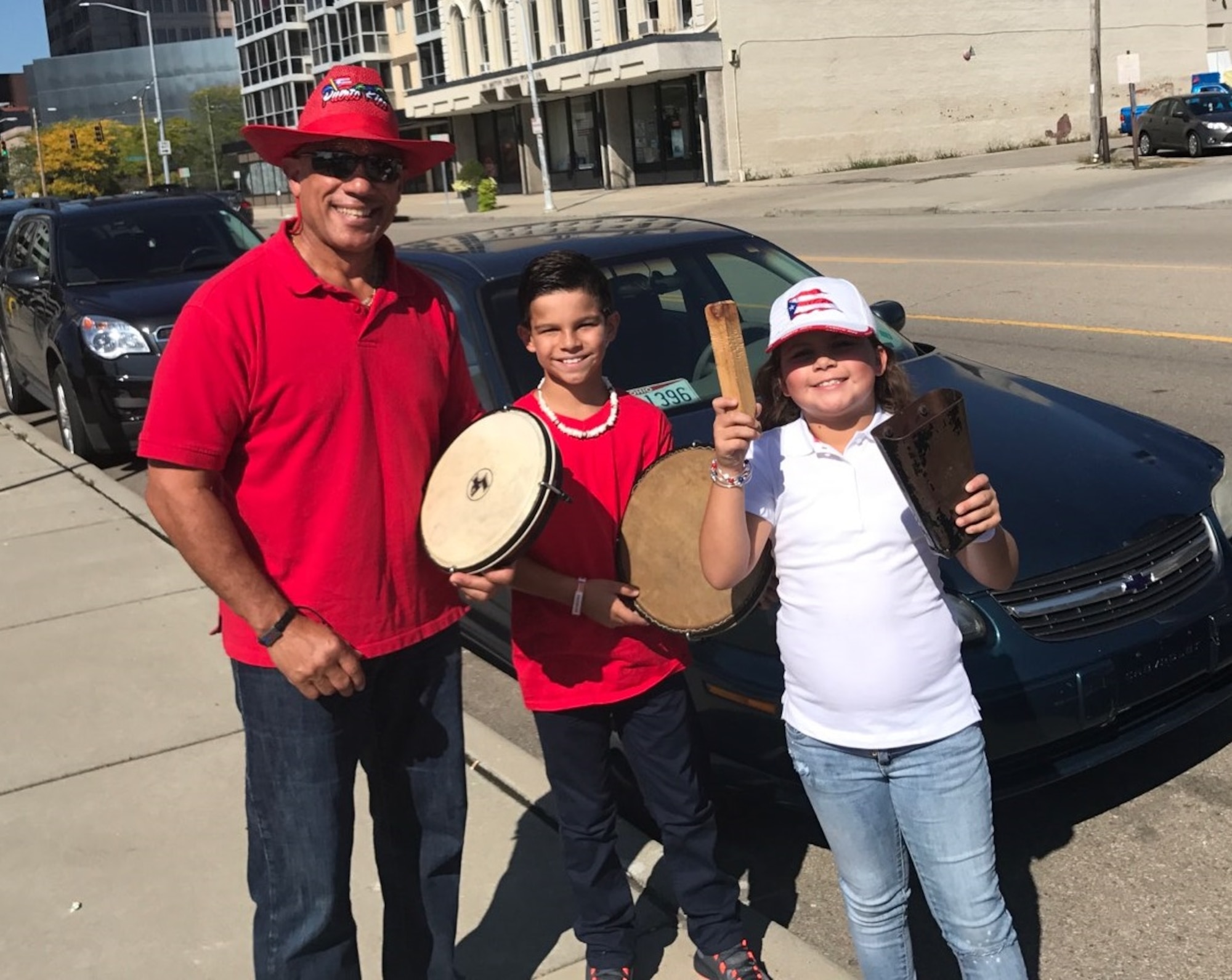 DAYTON, Ohio - Miguel Maldonado, Air Force Research Laboratory Fuels and Energy branch chief, poses with his grandchildren prior to performing at the 7th Annual Hispanic Heritage Festival & Parade in Dayton, Ohio Sept.16, 2017. Maldonado said he believes that mentoring, both cultural and profession, is everyone’s responsibility, but especially for those who have seen success in life. (Courtesy photo/Miguel Maldonado)
