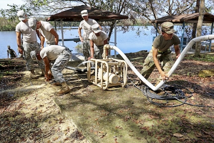 Soldiers use equipment to purify water from a lake.