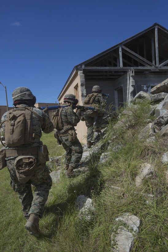 Marines with 2nd Battalion, 8th Marine Regiment enter a building during a military operation on urbanized terrain exercise at Camp Lejeune, N.C., Oct. 3, 2017. The Marines conducted MOUT training in preparation for their upcoming deployment to Japan. (U.S. Marine Corps photo by Lance Cpl. Ashley McLaughlin)