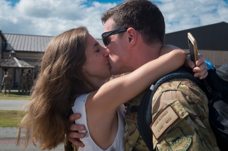 Capt. Evan Aldinger, 71st Rescue Squadron (RQS) HC-130J Combat King II pilot, embraces his wife, Allison, during a redeployment, Oct. 6, 2017, at Moody Air Force Base, Ga. Airmen from the 71st RQS supported deployed operations by providing expeditionary personnel with on-call recovery forces should they need to be rescued. (U.S. Air Force photo by Senior Airman Greg Nash)