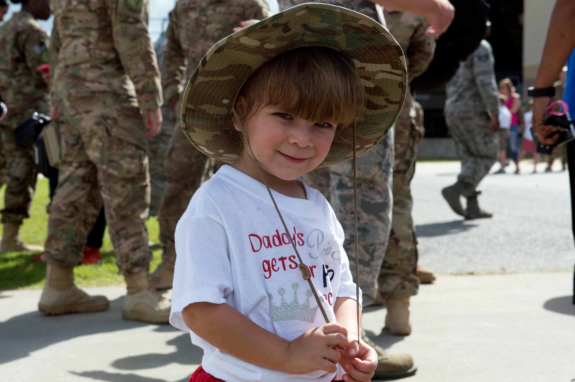 Olivia, daughter of Staff Sgt. Jacob Garcia, 23d Equipment Maintenance Squadron crash recovery team member, dons her father’s boonie hat after reuniting with him during a redeployment, Oct. 6, 2017, at Moody Air Force Base, Ga. Airmen from the 71st Rescue Squadron (RQS) supported deployed operations by providing expeditionary personnel with on-call recovery forces should they need to be rescued. (U.S. Air Force photo by Senior Airman Greg Nash)