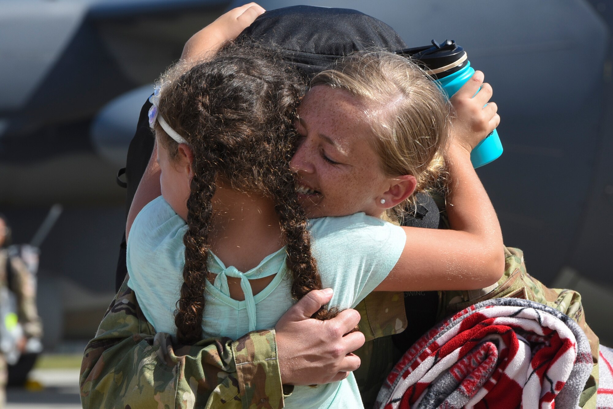 Master Sgt. Danielle Bruce-Salmon, 71st Rescue Squadron (RQS) special aviation resource management superintendent, hugs her daughter, Brooklyn, during a redeployment, Oct. 6, 2017, at Moody Air Force Base, Ga. Airmen from the 71st RQS supported deployed operations by providing expeditionary personnel with on-call recovery forces should they need to be rescued. (U.S. Air Force photo by Senior Airman Greg Nash)