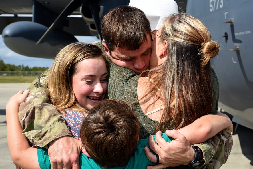 Tech. Sgt. James Anderson, 23d Equipment Maintenance Squadron aircraft structural maintainer, hugs his family during a redeployment, Oct. 6, 2017, at Moody Air Force Base, Ga. Airmen from the 71st Rescue Squadron (RQS) supported deployed operations by providing expeditionary personnel with on-call recovery forces should they need to be rescued. (U.S. Air Force photo by Senior Airman Greg Nash)