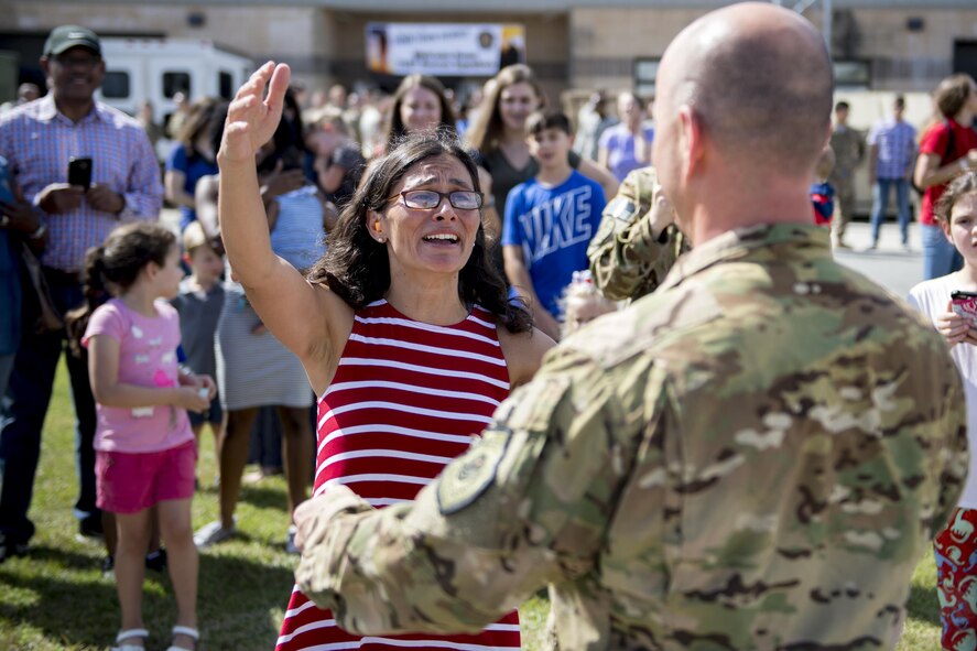 Claudia greets her husband, Lt. Col. Gary Symon, 71st Rescue Squadron (RQS) commander, during a redeployment, Oct. 6, 2017, at Moody Air Force Base, Ga. Airmen from the 71st RQS supported deployed operations by providing expeditionary personnel with on-call recovery forces should they need rescued. (U.S. Air Force photo by Airman 1st Class Daniel Snider)