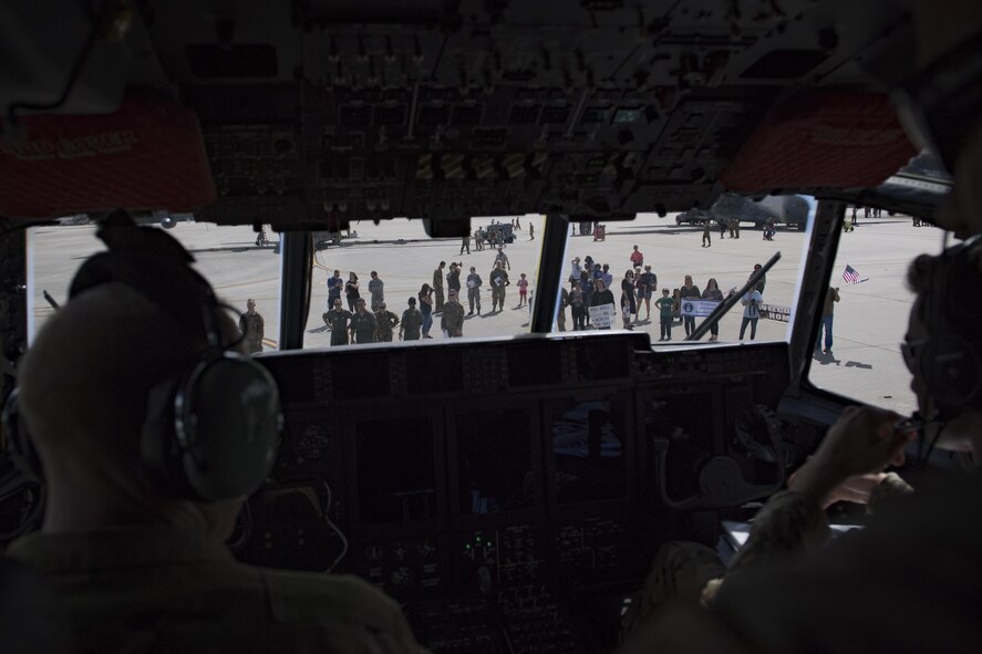 Families wait outside of a 71st Rescue Squadron (RQS) HC-130J Combat King II during a redeployment, Oct. 6, 2017, at Moody Air Force Base, Ga. Airmen from the 71st RQS supported deployed operations by providing expeditionary personnel with on-call recovery forces should they need rescued. (U.S. Air Force photo by Airman 1st Class Daniel Snider)