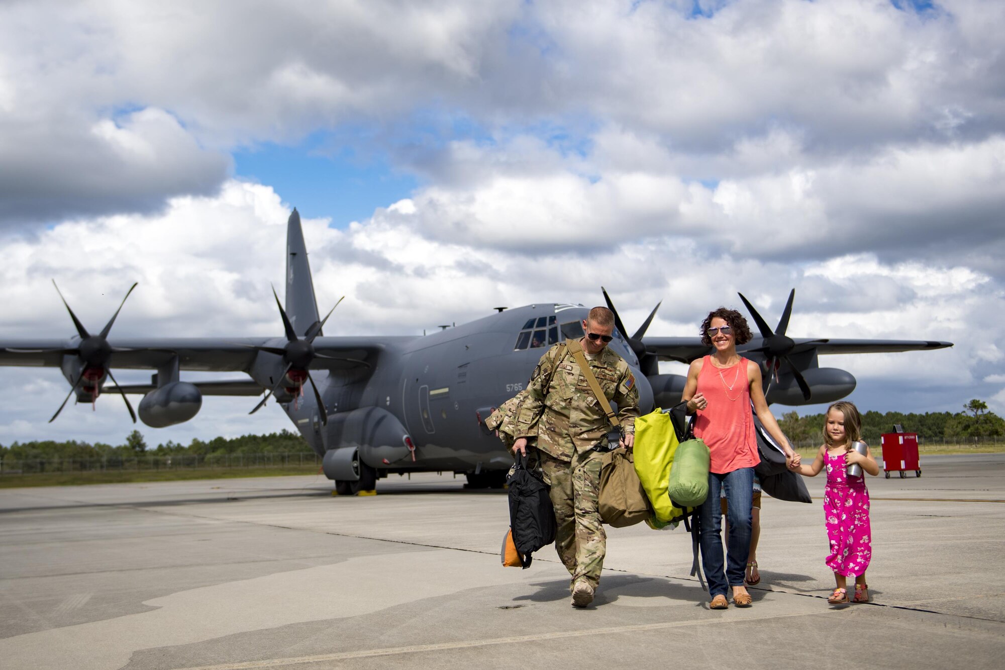Tech. Sgt. Michael Guerra, 71st Rescue Squadron (RQS) loadmaster, departs an HC-130J Combat King II with his family during a redeployment, Oct. 6, 2017, at Moody Air Force Base, Ga. Airmen from the 71st RQS supported deployed operations by providing expeditionary personnel with on-call recovery forces should they need rescued. (U.S. Air Force photo by Airman 1st Class Daniel Snider)