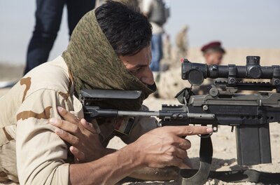 Soldier firing a rifle.