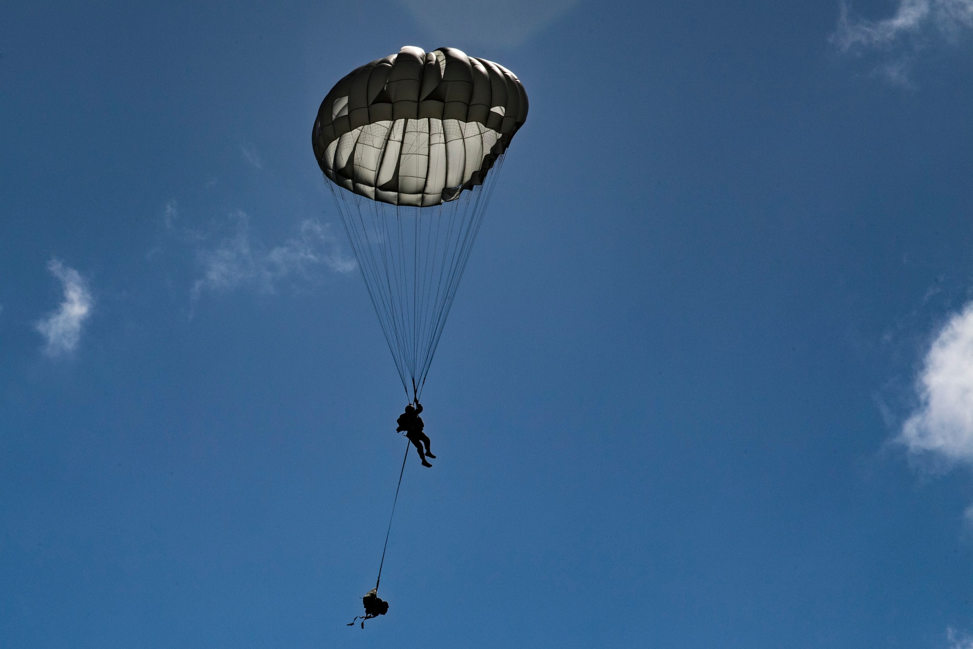 A member of the 820th Base Defense Group descends during a static-line jump, Oct. 3, 2017, at the Lee Fulp drop zone in Tifton, Ga. During a static-line jump, the jumper is attached to the aircraft via the ‘static-line’, which automatically deploys the jumpers’ parachute after they’ve exited the aircraft.(U.S. Air Force photo by Airman 1st Class Daniel Snider)