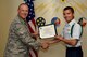 U.S. Air Force Lt. Col. Steven Watts, 17th Training Group deputy commander, 315th Training Squadron Student of the Month award for Sept. 2017 to Airman Ryan Woodhouse, 312th Training Squadron trainee, in the Brandenburg Hall on Goodfellow Air Force Base, Texas, Oct. 5, 2017. The 17th Training Wing's mission is to develop and inspire exceptional intelligence, surveillance and reconnaissance, and fire protection professionals for America and her allies. (U.S. Air Force photo by Airman 1st Class Randall Moose/released)