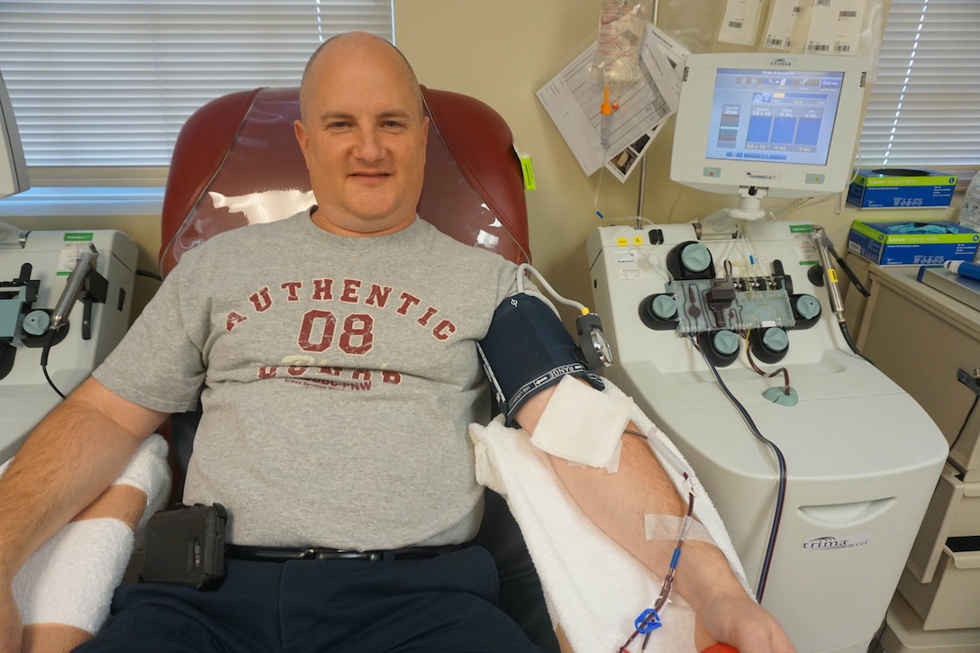 Aaron Boone, finance specialist for the Western Air Defense Sector, donates blood platelets Oct. 5 at the Armed Services Blood Bank Center Pacific Northwest.  He was named an American Red Cross Hometown Hero for donating blood platelets 26 times over a 15-month period. (Photo Courtesy of Aaron Boone)