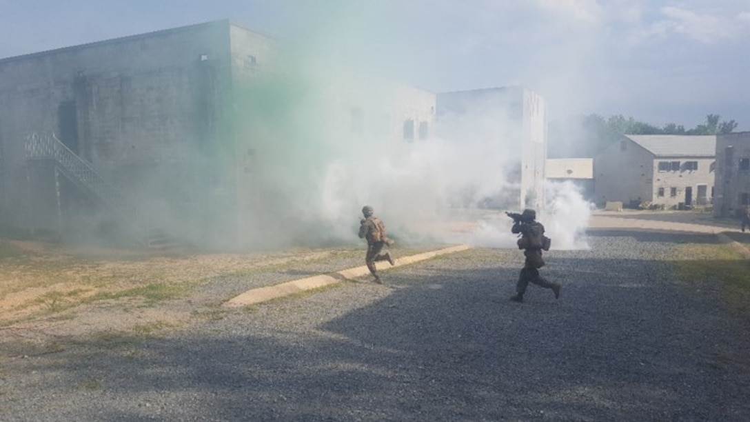 Marines with 5th Platoon, Charlie Co. Fleet Anti-terrorism, Security Team, Marine Corps Security Forces Regiment run under smoke cover during a training exercise at Marine Corps Base Quantico. Marines executed a military operations urban terrain and interior tactics field exercise at the Range Shoot House in order to enhance the platoon’s ability to fight in an urban environment. From August 8-17.