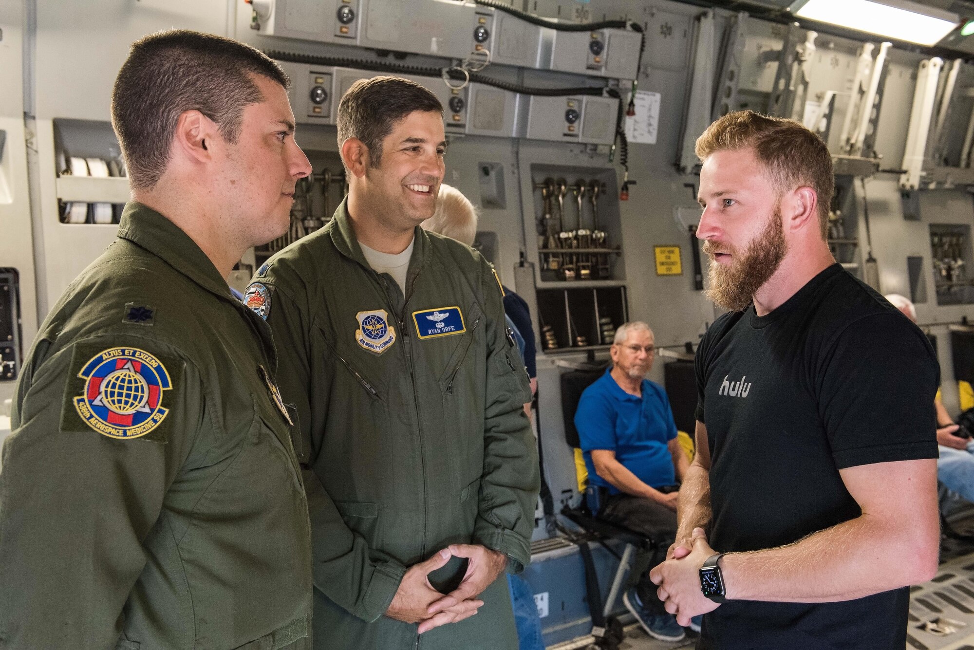 Lt. Cols. Paul DeFlorio, 436th Aerospace Medicine Squadron commander, and Ryan Orfe, 3d Airlift Squadron pilot and special projects officer, talk with Jeffrey Earnhardt, Monster Energy NASCAR Cup Series driver, in the cargo compartment of a C-17 Globemaster III Sept. 29, 2017, on Dover Air Force Base, Del. During the NASCAR orientation flight, Earnhardt observed the C-17 being refueled by KC-135T Stratotankers from the 127th Wing, Selfridge Air National Guard Base, Mich. (U.S. Air Force photo by Roland Balik)