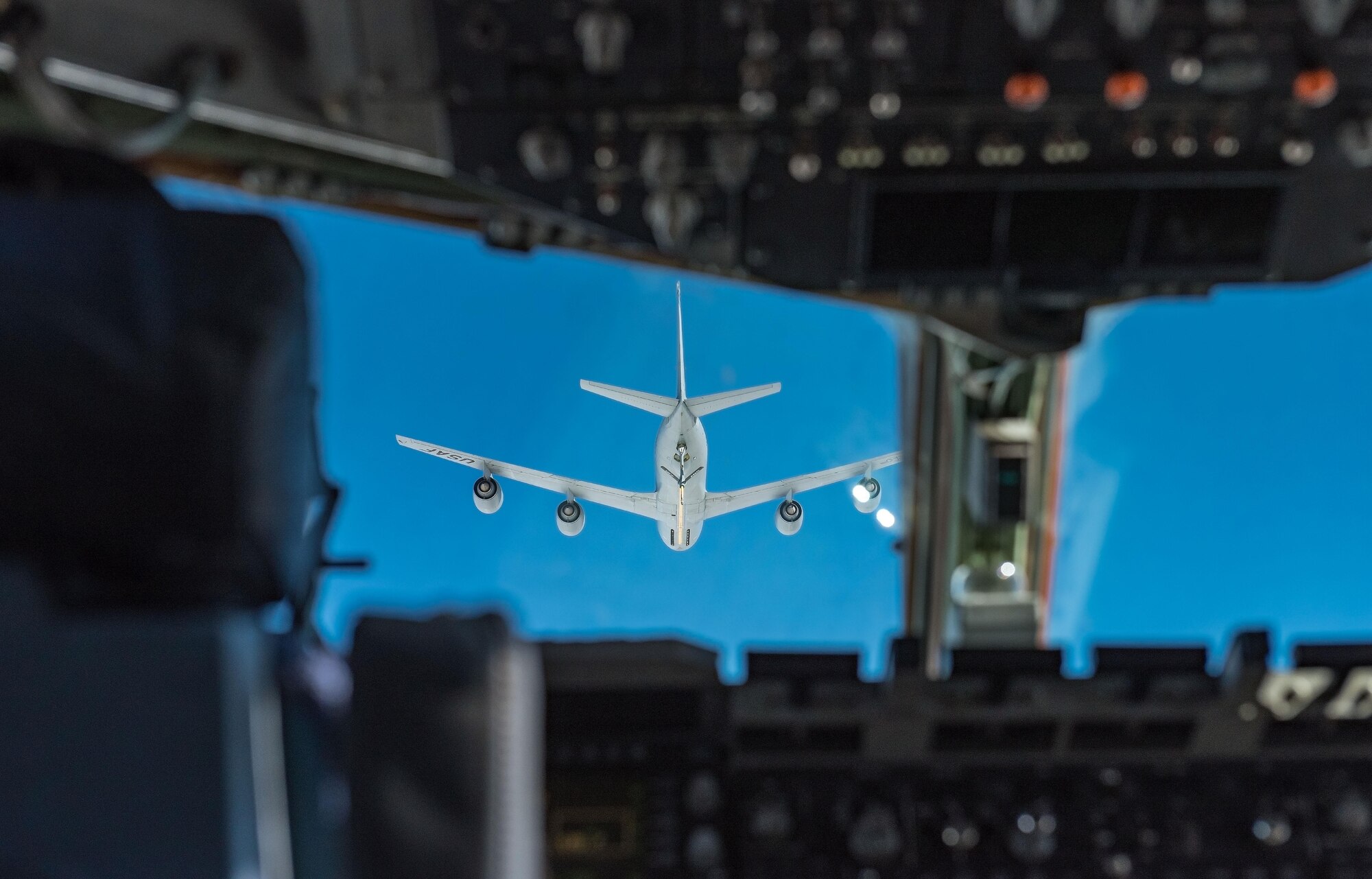 Pilots from the 3d Airlift Squadron, Dover Air Force Base, Del., slowly fly their C-17 Globemaster III into position during an air refueling training mission Sept. 28, 2017. On this training mission, NASCAR orientation flight participants took turns observing air refueling operations by KC-135T Stratotankers from the 127th Wing, Selfridge Air National Guard Base, Mich. (U.S. Air Force photo by Roland Balik)