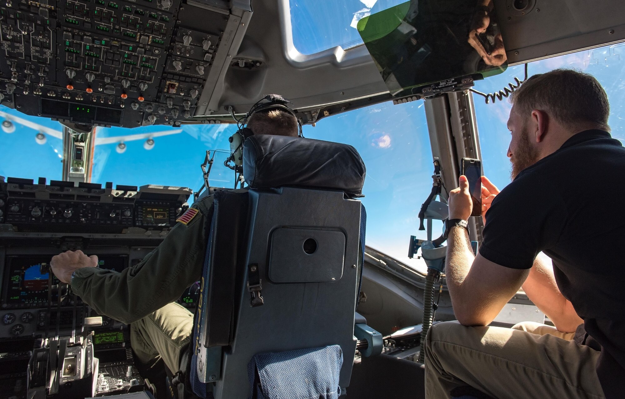 Jeffrey Earnhardt, Monster Energy NASCAR Cup Series driver, observes and records 3d Airlift Squadron pilots flying a C-17 Globemaster III into position for air refueling Sept. 28, 2017, out of Dover Air Force Base, Del. Earnhardt observed the Globemaster III being refueled by KC-135T Stratotankers from the 127th Wing, Selfridge Air National Guard Base, Mich. (U.S. Air Force photo by Roland Balik)