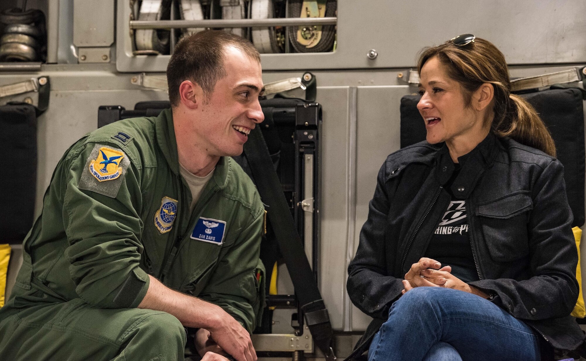In the cargo compartment of a C-17 Globemaster III, Capt. Sam Davis, 3d Airlift Squadron pilot, talks with Kimberle Burton, mother of Harrison Burton, NASCAR K&N Pro Series East driver, as the aircraft flies back to Dover Air Force Base, Del., Sept. 28, 2017. More than 20 NASCAR orientation flight participants observed the Globemaster III being air refueled by KC-135T Stratotankers from the 127th Wing, Selfridge Air National Guard Base, Mich., during the three-hour flight. (U.S. Air Force photo by Roland Balik)