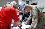 Lt. Gen. Jeffrey S. Buchanan (right), commander, U.S. Army North (Fifth Army) at Jint Base San Antonio-Fort Sam Houston, and Joint Forces Land Component Commander forward in Puerto Rico, consults with officials from the Federal Emergency Management Agency and the Commonwealth of Puerto Rico to provide logistical distribution of water, food and medical capabilities.