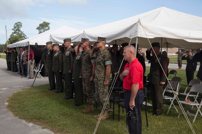 Marines and Sailors salute for the national anthem during an anniversary ceremony at Camp Lejeune, N.C., Oct. 6, 2017. Marines of past and present gathered to commemorate the 100th anniversary of the inception of 8th Marine Regiment. The unit was established Oct. 9, 1917. (U.S. Marine Corps photo by Pfc. Nicholas Guevara)