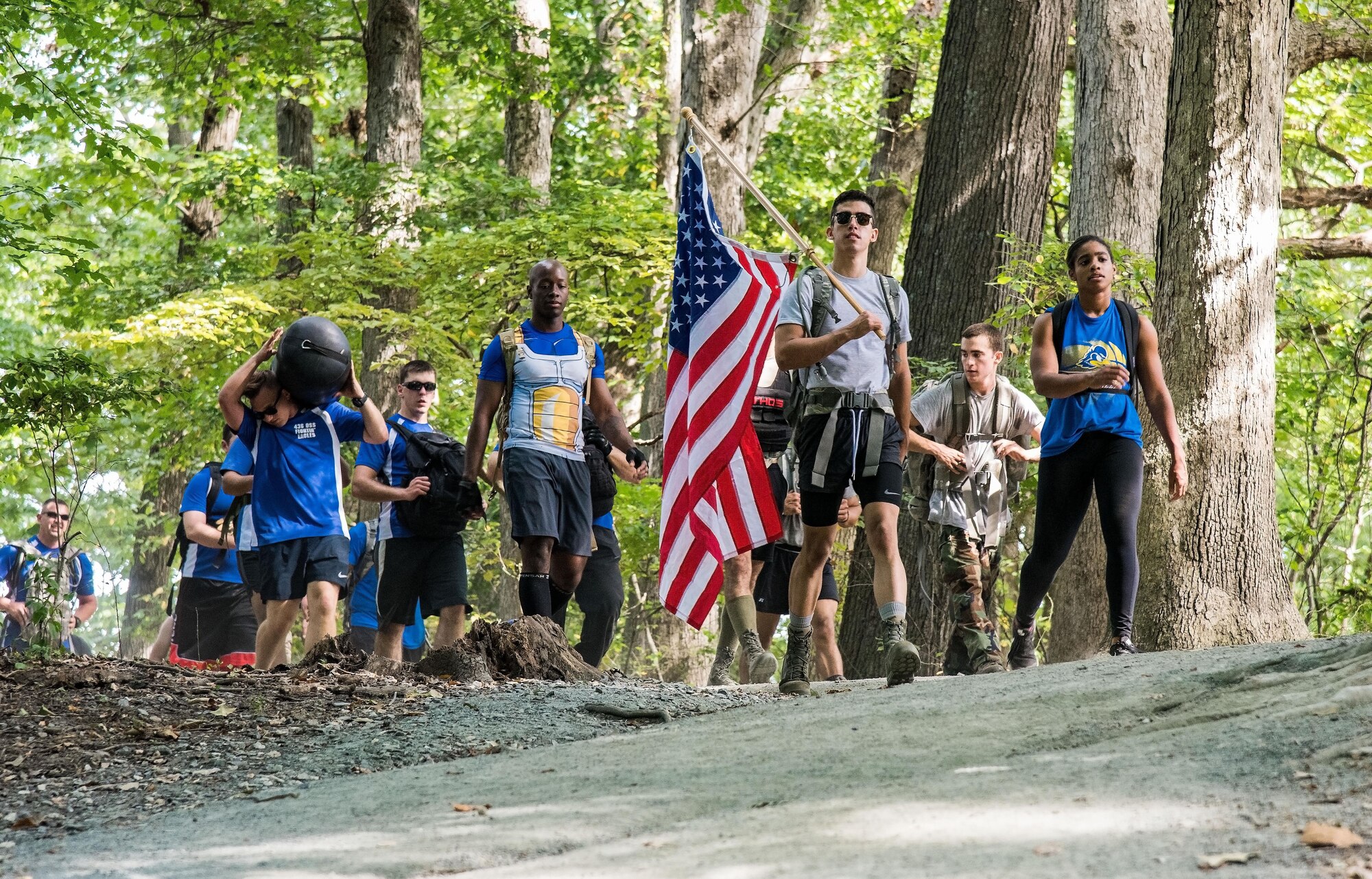 Participants in the 2017 GORUCK Light Challenge make their way around the hiking trail Oct. 6, 2017, at Brecknock Park in Camden, Del. Participants completed three laps while carrying their rucksack, chains and a punching bag. (U.S. Air Force photo by Roland Balik)