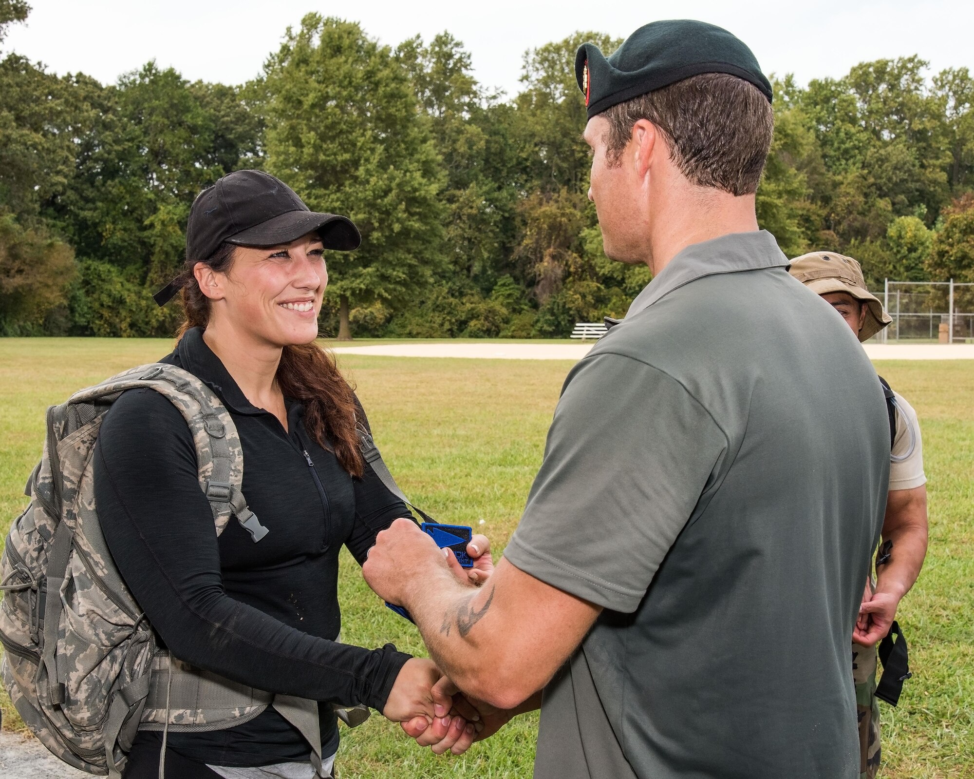 Brittany Bailey, 436th Logistics Readiness Squadron vehicle mechanic, receives her 2017 GORUCK Light patch from U.S. Army Master Sgt. Todd Fetzer, 1st Special Forces Command (Airborne), Ft. Bragg, N.C., Oct. 6, 2017, at Brecknock Park in Camden, Del. Bailey was one of 29 individuals who completed the GORUCK Challenge. (U.S. Air Force photo by Roland Balik)