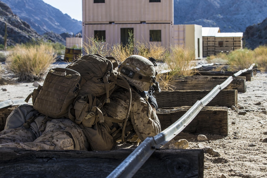 a Marine positions himself on railroad tracks during training.
