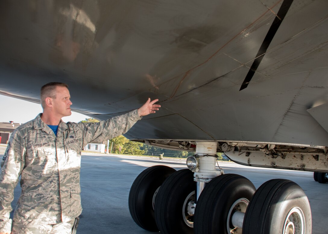 Master Sgt. D.J. Little, a 94th Maintenance Squadron hydraulic technician, points to excess hydraulic fluid on the exterior of a C-5M Super Galaxy at Dobbins Air Reserve Base, Ga. Oct. 6, 2017. The aircraft had a faulty actuator which caused hydraulic fluid to spray out and prevented the visor of the C-5 from opening. Little worked alongside technicians from Dover Air Force Base, Dela. to create custom hydraulic hoses to bypass the faulty actuator to make the necessary repairs so the plane could take communication equipment to Puerto Rico. (U.S. Air Force photo/Staff Sgt. Andrew Park)