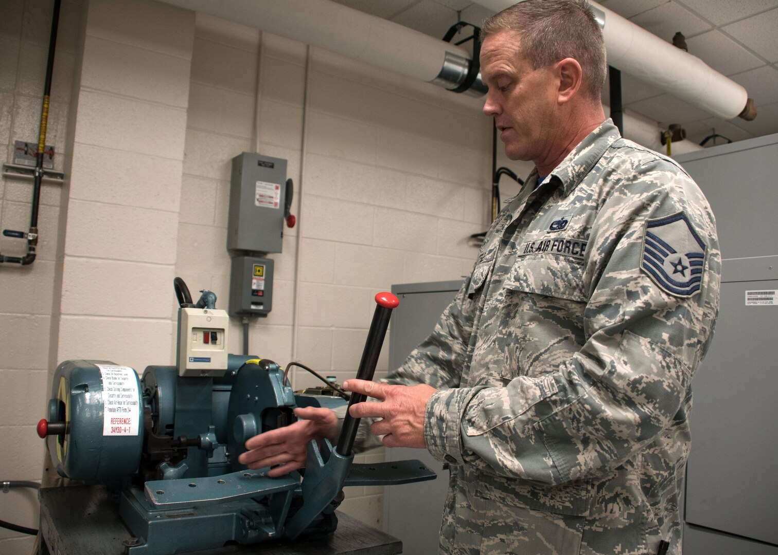 Master Sgt. D.J. Little, a 94th Maintenance Squadron hydraulic technician, demonstrates the tool he used to cut hydraulic hoses for a C-5M Super Galaxy at Dobbins Air Reserve Base, Ga. Oct. 6, 2017. The hoses were used to bypass a faulty actuator that prevented the visor of the aircraft from opening so that vital communication could be offloaded in Puerto Rico. (U.S. Air Force photo/Staff Sgt. Andrew Park)