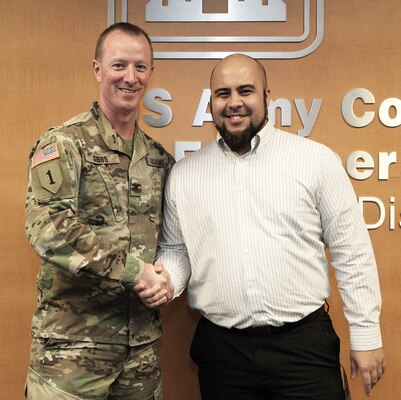Mike Robinson, contract specialist, U.S. Army Corps of Engineers Los Angeles District, right, is congratulated by Col. Kirk Gibbs, District commander, left, during the Oct. 5 End of the Year Celebration at the District headquarters in downtown LA.