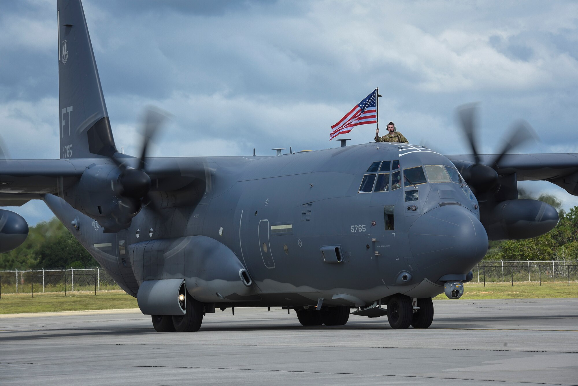 An Airman waves an American flag prior to celebrating with loved ones during a redeployment, Oct. 6, 2017, at Moody Air Force Base, Ga. Airmen from the 71st Rescue Squadron (RQS) supported deployed operations by providing expeditionary personnel with on-call recovery forces should they need to be rescued. (U.S. Air Force photo by Senior Airman Greg Nash)