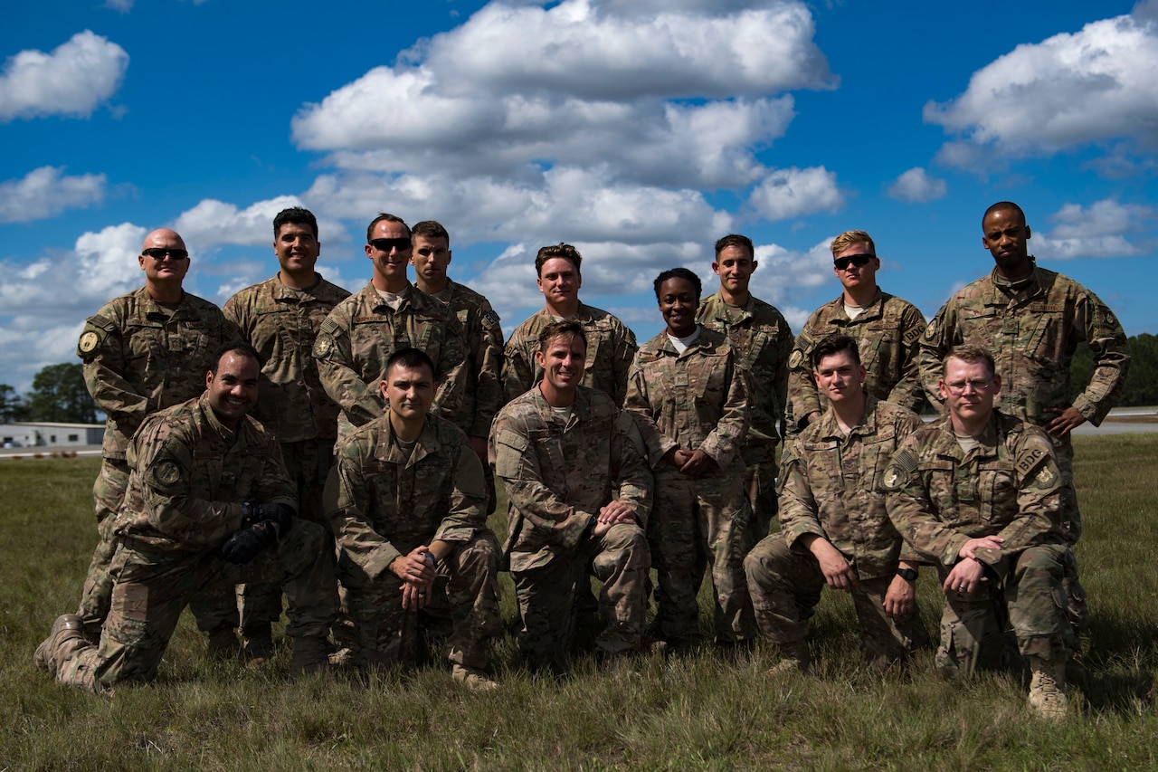 Members of the 820th Base Defense Group pose with Tech. Sgt. Joe Ostrum, 820th Combat Operations Squadron personal parachute program manager, front, third from the left, after he earned his senior-rated parachutist badge during a static-line jump, Oct. 3, 2017, at the Lee Fulp drop zone in Tifton, Ga. During a static-line jump, the jumper is attached to the aircraft via the ‘static-line’, which automatically deploys the jumpers’ parachute after they’ve exited the aircraft. (U.S. Air Force photo by Airman 1st Class Daniel Snider)