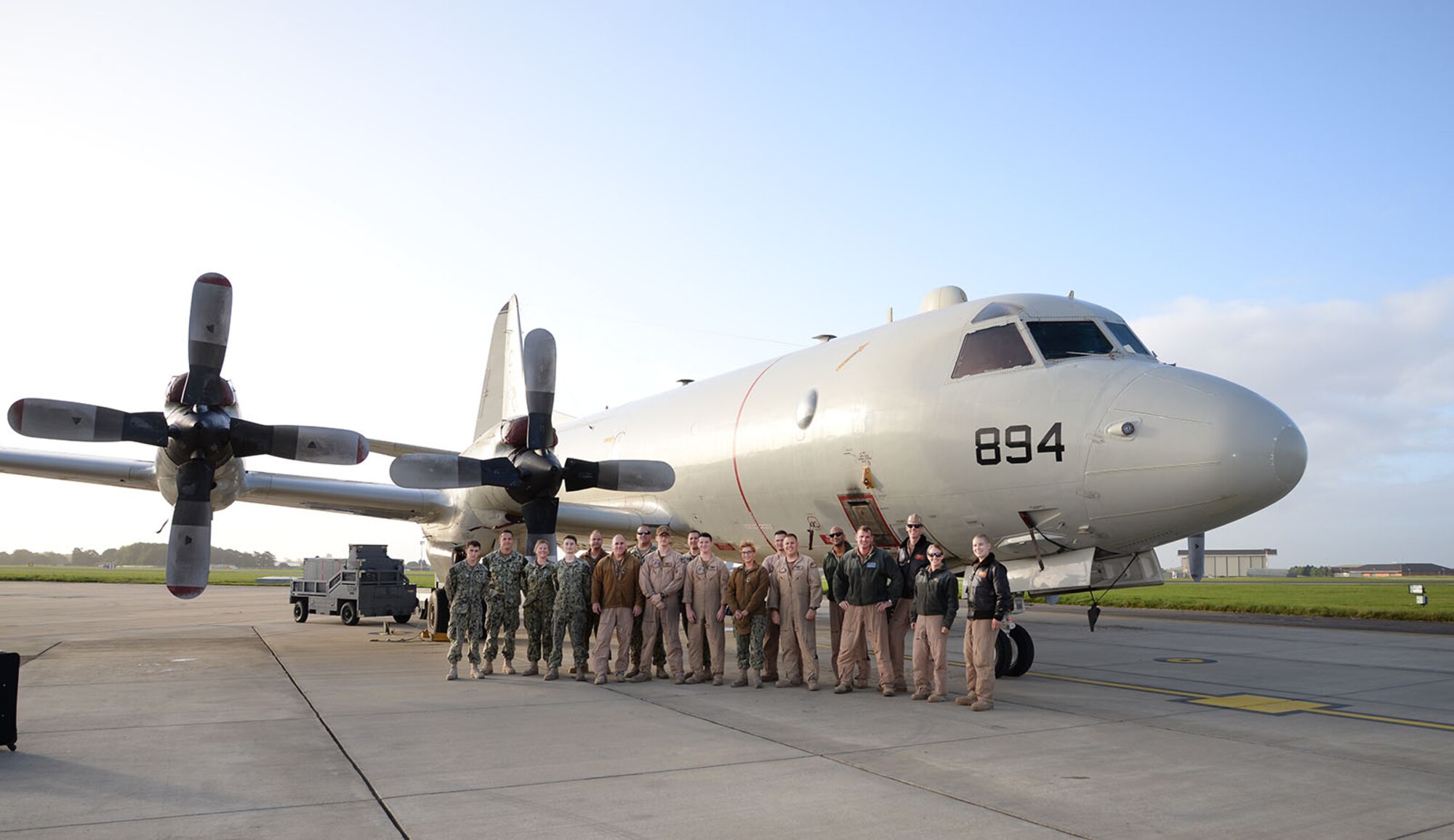 Crew from a U.S. Navy P-3C Orion aircraft pose for a photo before preparing their aircraft for the journey home to Naval Air Station Whidbey Island, Wash., Oct. 2, 2017, on RAF Mildenhall, England. The VP-46 Grey Knights, Naval Air Station Whidbey Island, Wash., were returning from a six-month deployment in support of U.S. Central Command operations and are now on their way home. (U.S. Air Force photos by Karen Abeyasekere)