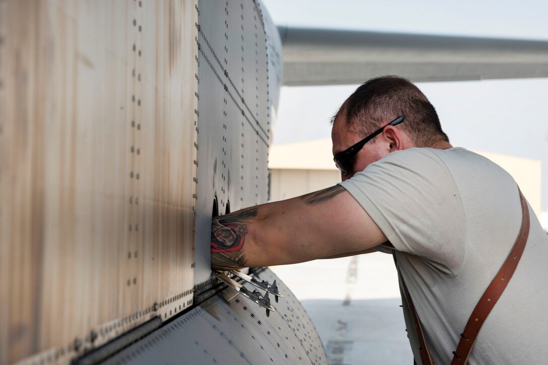 Airman 1st Class Alex Douglas performs preflight inspections on a C-130J Super Hercules aircraft.