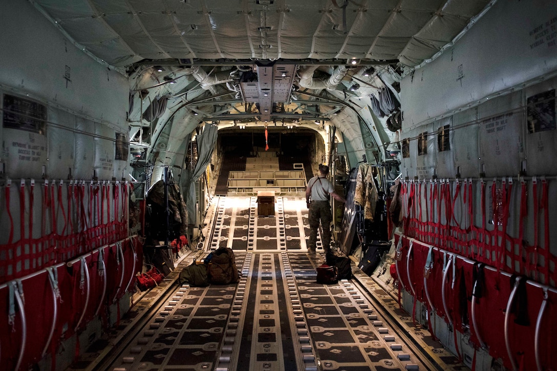 Airman 1st Class Alex Douglas performs preflight inspections inside a C-130J Super Hercules aircraft.