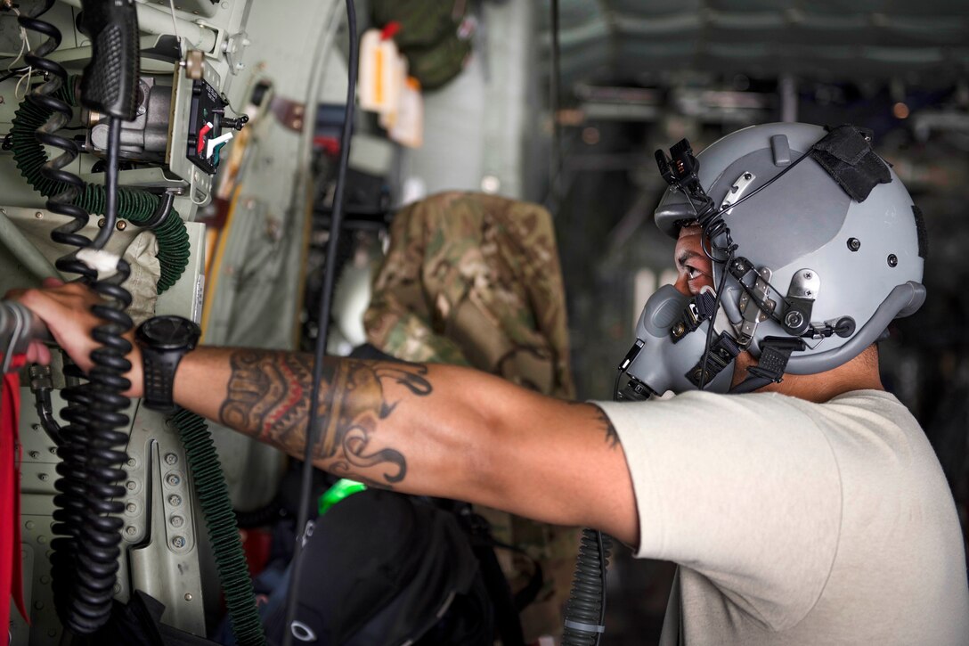 Staff Sgt. Matthew Ortiz checks his helmet and flight gear before taking off on a mission.
