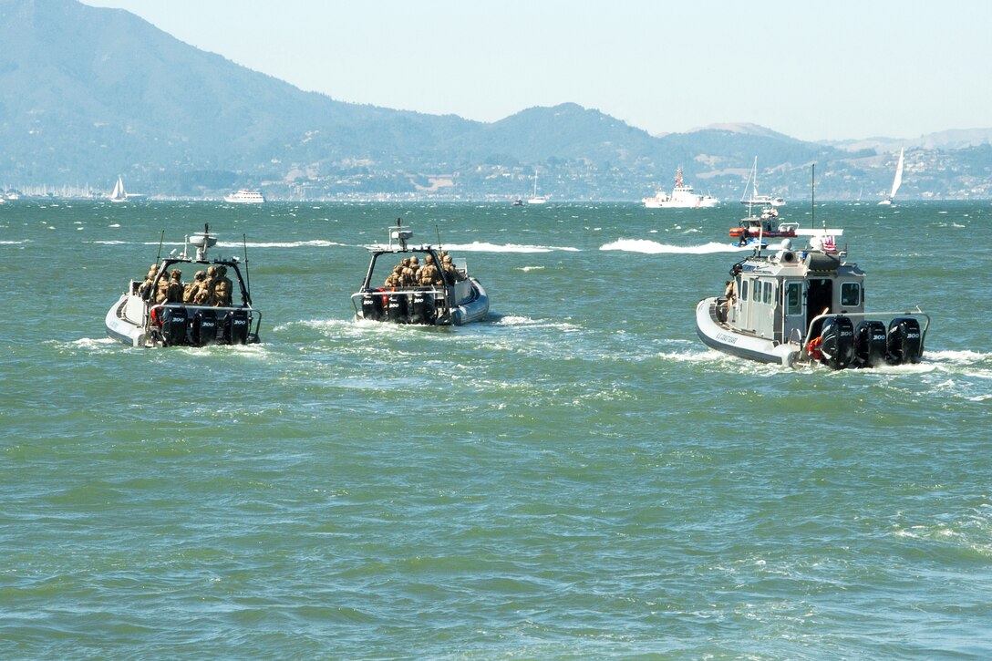 Coast Guard members maneuver their boats conducting security patrols in the bay during San Francisco Fleet Week