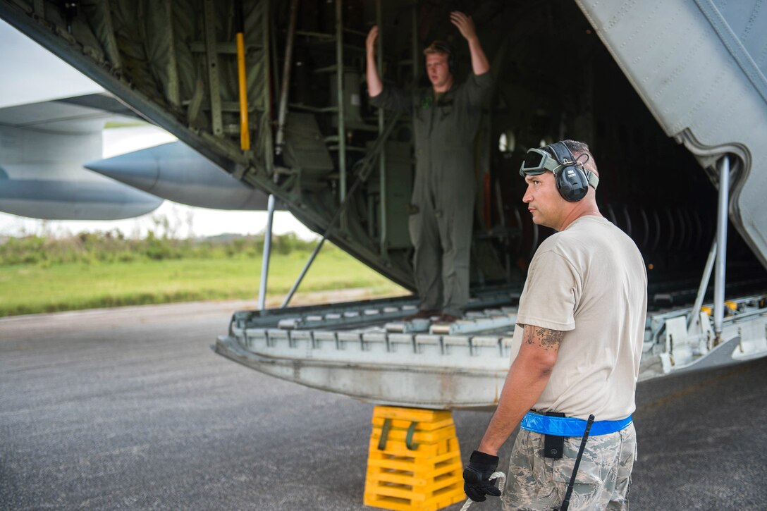 Tech. Sgt. Christopher Swartz looks on as a K-loader approaches a Marine KC-130 Super Hercules aircraft.