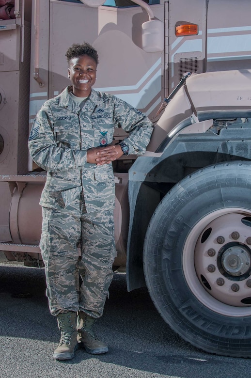 Master Sgt. Mendy Dillard poses for a portrait beside a fire truck at an undisclosed location in Southwest Asia Wednesday, 11 October 2017. Dillard is celebrating her 11th year serving the Air Force as a firefighter. (U.S. Air Force photo by Master Sgt. Eric M. Sharman)