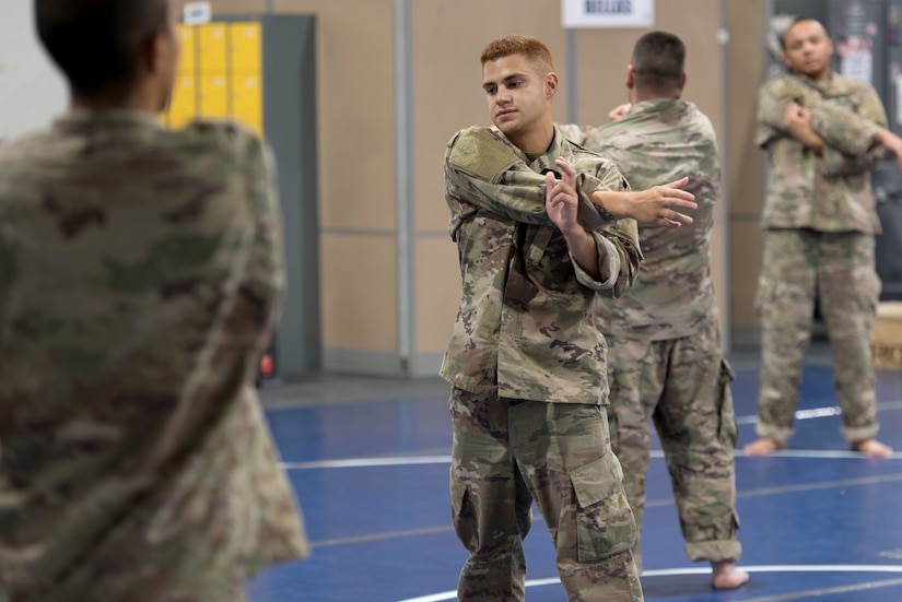 Soldiers warm up with stretching before the course.