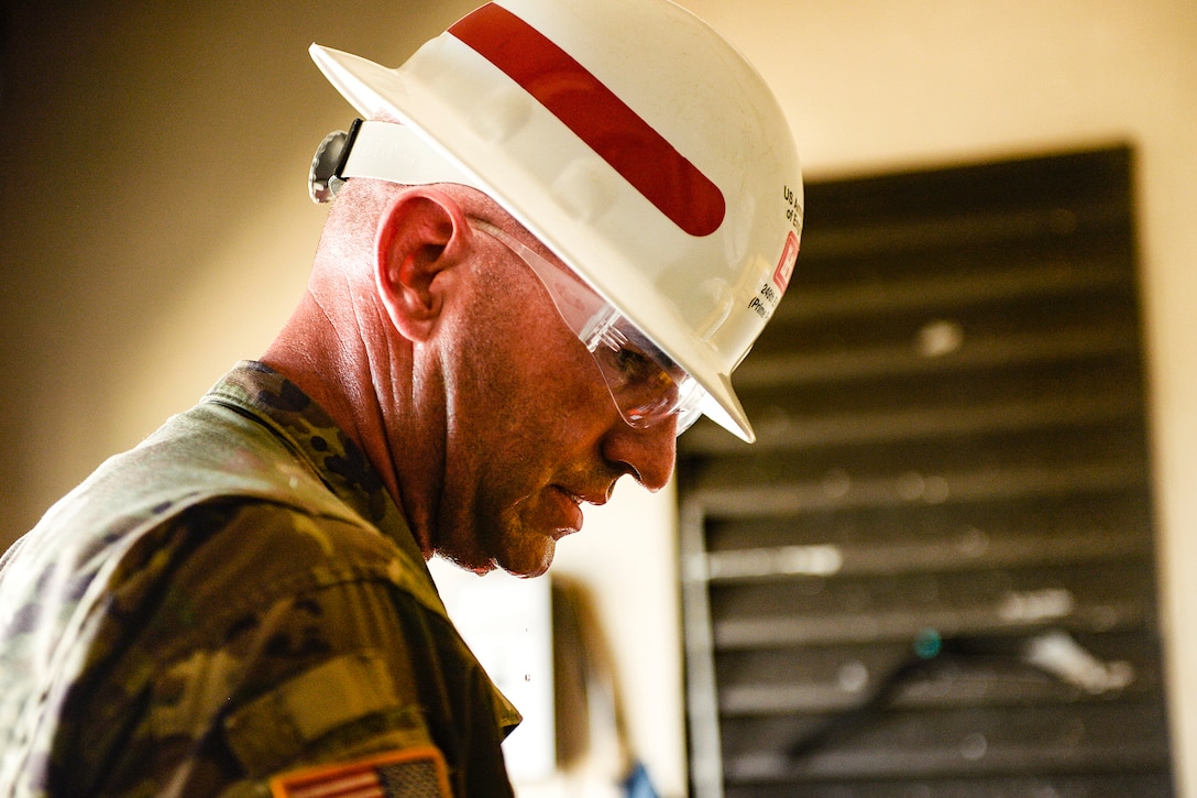 Army Sgt. Jesse Johnson works to install a generator for the Susana Centeno Diagnostic and Treatment Center.