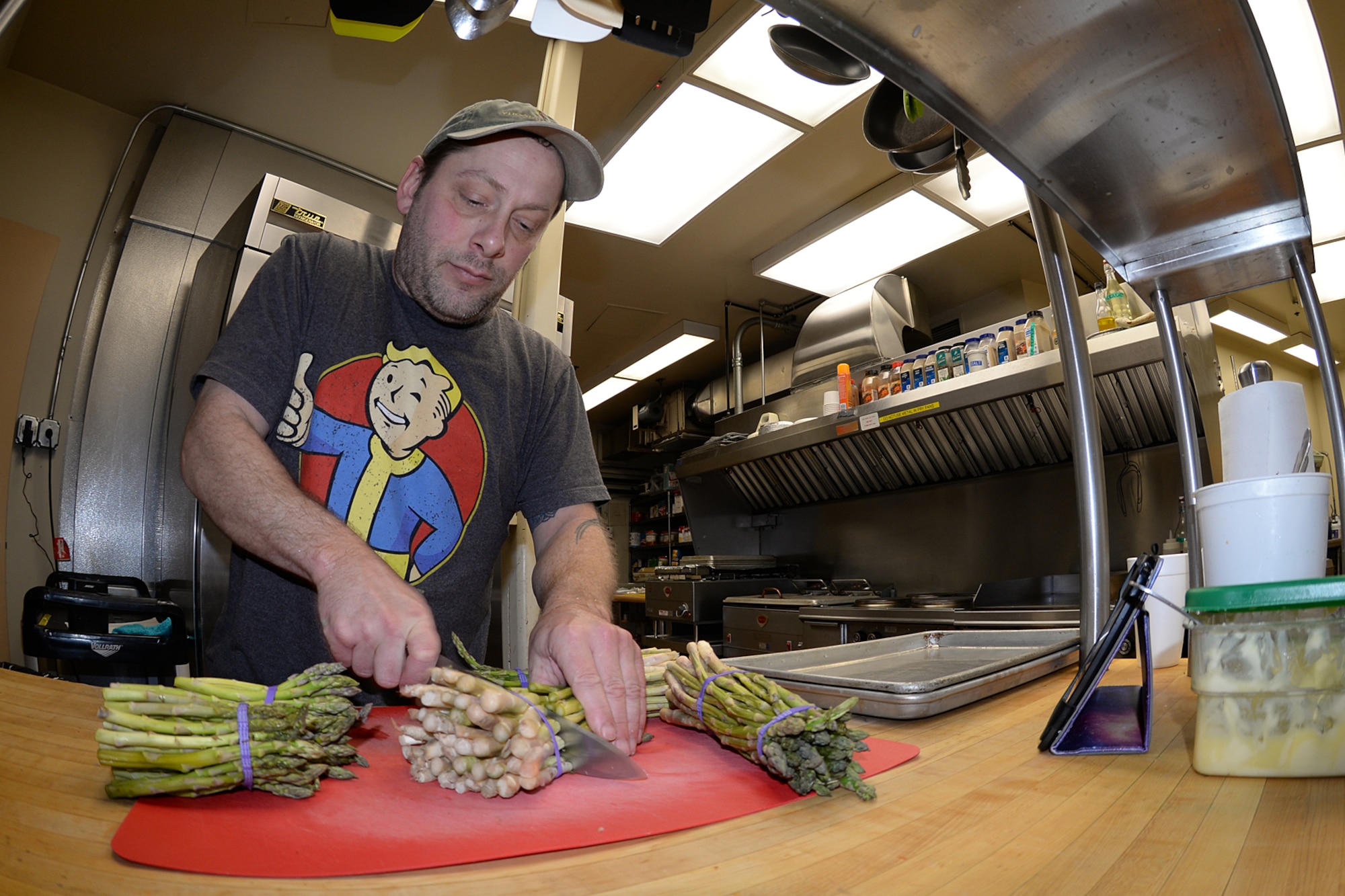 Sean Fenderson, ARCTEC services technician, chops asparagus in preparation for the evening meal on Sep. 27, 2017. The North Pole, Alaska, resident has worked at most radar sites operated by ARCTEC during his five year employment and is on his second assignment to Cape Romanzof. (U.S. Air Force photo by Alex R. Lloyd)