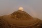 Sun, wind and clouds surround the long range radar radome at the top of Towak Mountain, Cape Romanzof, Alaska, on Sep. 26, 2017. The weather is the biggest factor that affects team members ability to accomplish their maintenance mission. (U.S. Air Force photo by Alex R. Lloyd)