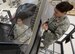 U.S. Air Force Staff Sgt. Amanda Dennis, F-35 Field Training Detachment egress instructor, explains an F-35 ejection seat maintenance trainer to Chief Master Sgt. David Brown, 19th AF command chief, Oct. 3, 2017, at Eglin Air Force Base, Fla. During Brown's visit at the 33rd Fighter Wing, Brown experienced the one-of-a-kind training facility where F-35 maintainers hone their craft by using state of the art equipment. (U.S. Air Force photo by Staff Sgt. Peter Thompson)