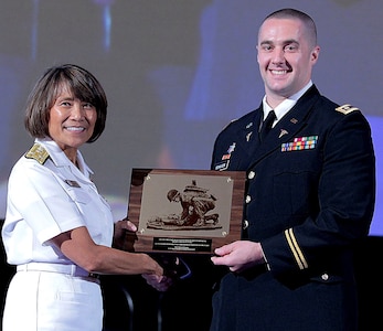 Vice Adm. Raquel Bono, Director, Defense Health Agency, presents Maj. (Dr.) Steven Schauer, of the U.S. Army Institute of Surgical Research at Joint Base San Antonio-Fort Sam Houston. with the 2017 Military Health System Research Symposium award for Outstanding Research Accomplishment (military/individual) Aug. 26.