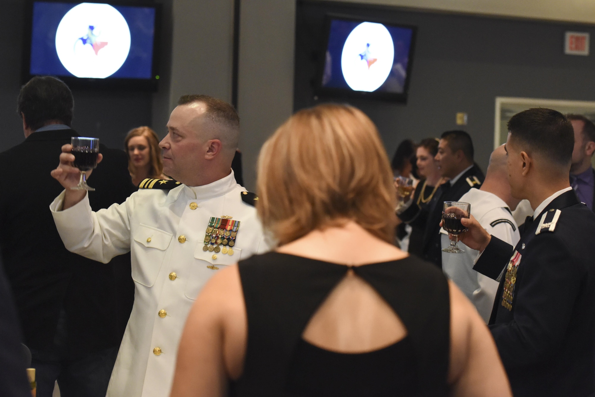 U.S. Navy Lt. Cmdr. Christopher Allen, Center for Information Warfare Training Detachment Goodfellow officer in charge, joins the traditional toast and response at the Navy Ball on Goodfellow Air Force Base, Texas Oct. 6, 2017. The toast pays respect to the President of the United States, the Secretary of Defense, and to all of the armed forces. (U.S. Air Force photo by Airman Zachary Chapman/Released)