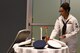 U.S. Navy Petty Officer 1st Class Diana Williams, Center for Information Warfare Training Detachment Goodfellow instructor, places a single rose on the POW/MIA table during the Navy Ball at the Event Center on Goodfellow Air Force Base, Texas Oct. 6, 2017. The POW/MIA table is set each ball in remembrance of those who are unable or longer able to join. (U.S. Air Force photo by Airman Zachary Chapman/Released)