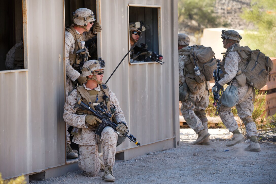 Marines provide security for team members during a weapons and tactics instructor course