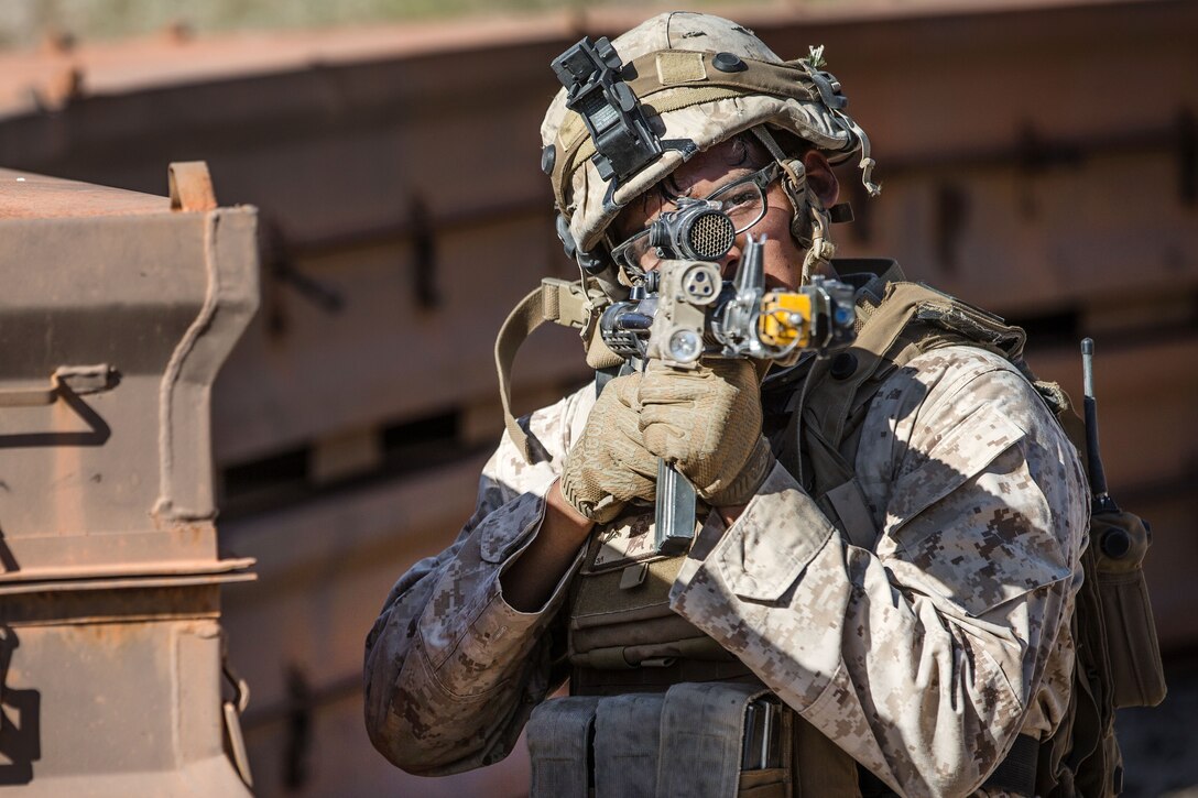 A Marine takes aim at mock opposing forces during a weapons and tactics instructor course.